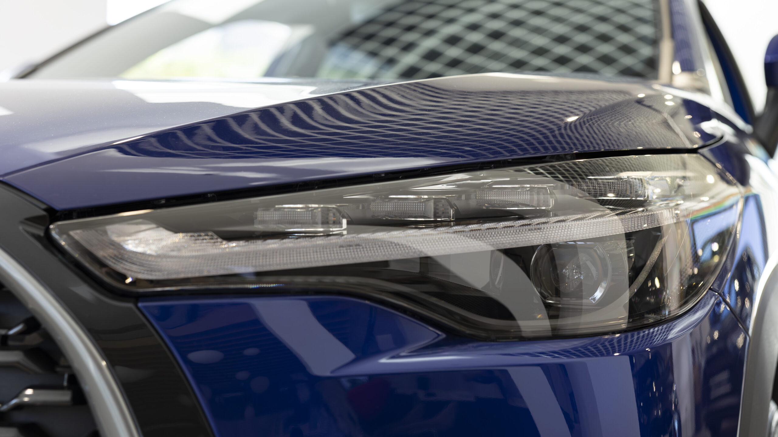 Panning shot of cars with sleek design in showroom waiting to be purchased